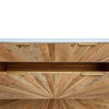 Perspective detail shot highlighting the sunburst wood inlay pattern meeting the clean white top edge of the dresser