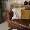 Close-up lifestyle shot of the Channel sofa's leather armrest and cushions