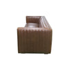 Side profile of the Channel sofa highlighting vertical leather tufting