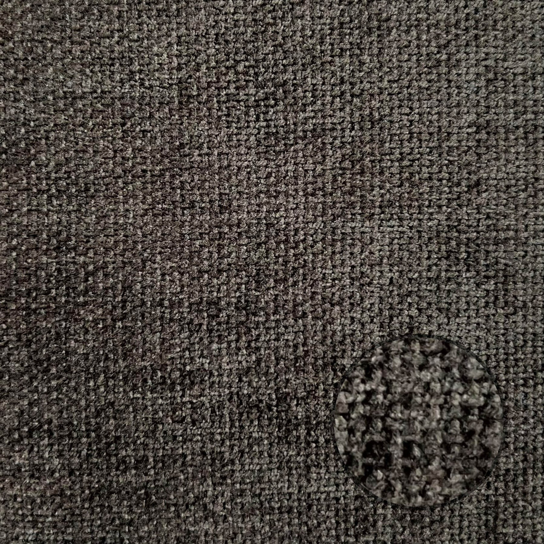 Full-frame macro shot of the charcoal grey textured weave upholstery for material reference