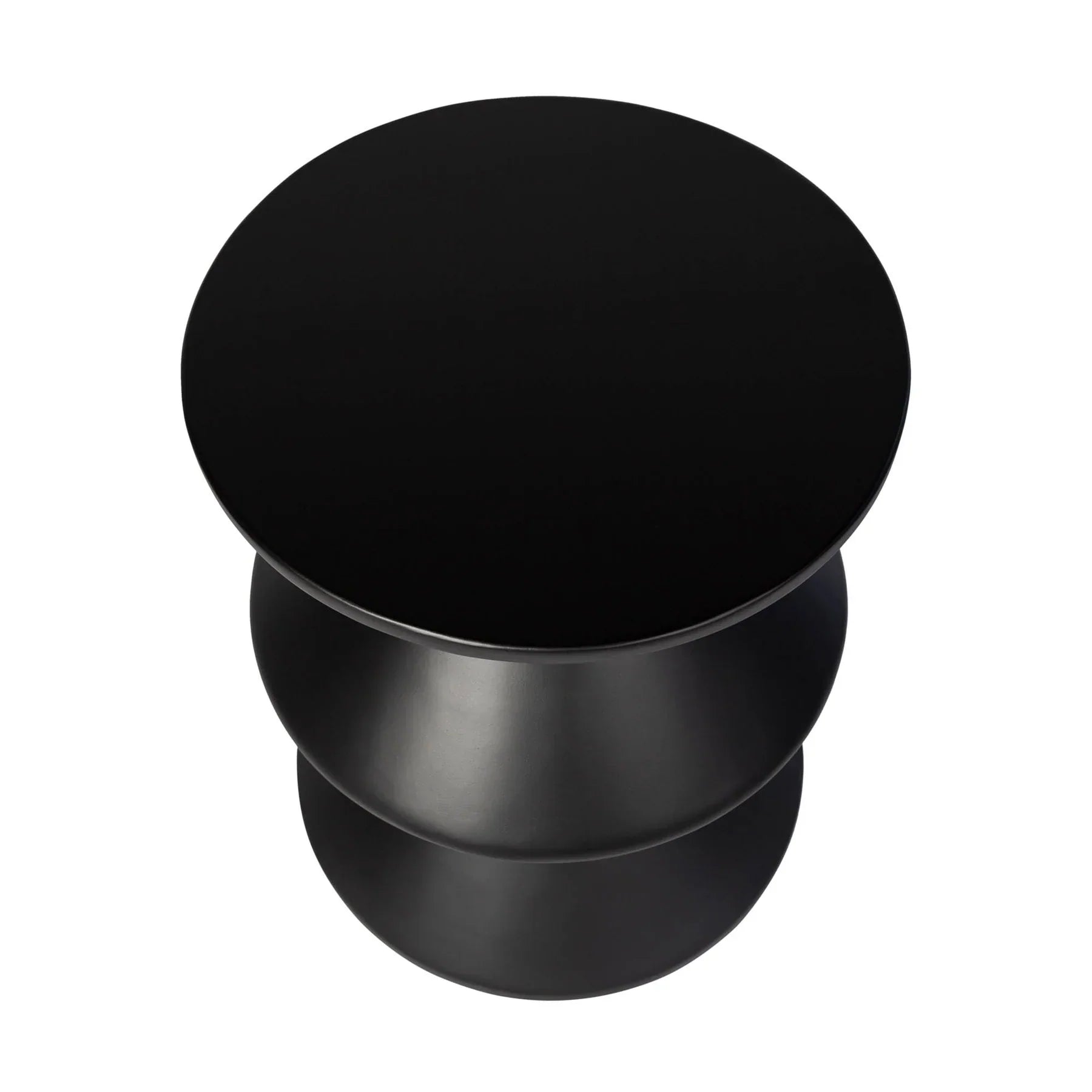 Three-quarter view of the concrete inverted side table featuring a matte black finish and a bold three-tier geometric zig-zag silhouette