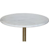 Close-up perspective shot highlighting the smooth polished surface and subtle grey veining of the round white marble tabletop