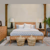 High-angle lifestyle shot featuring the dresser styled with a white ceramic lamp and decorative accents in a modern studio