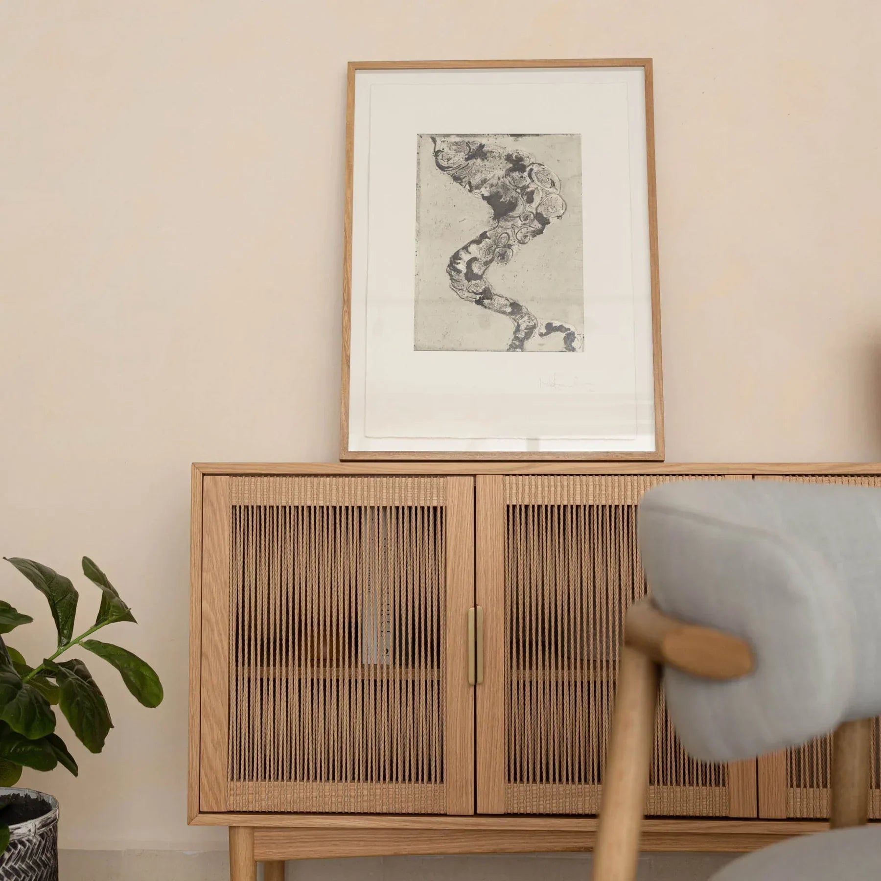 Front perspective view of the Lumina 4-door sideboard featuring a light oak wood frame, fluted glass door panels, and elegant vertical gold metal handles