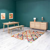 Alternative lifestyle shot showcasing the Gia sideboard in a fully decorated dining space with a colorful geometric rug