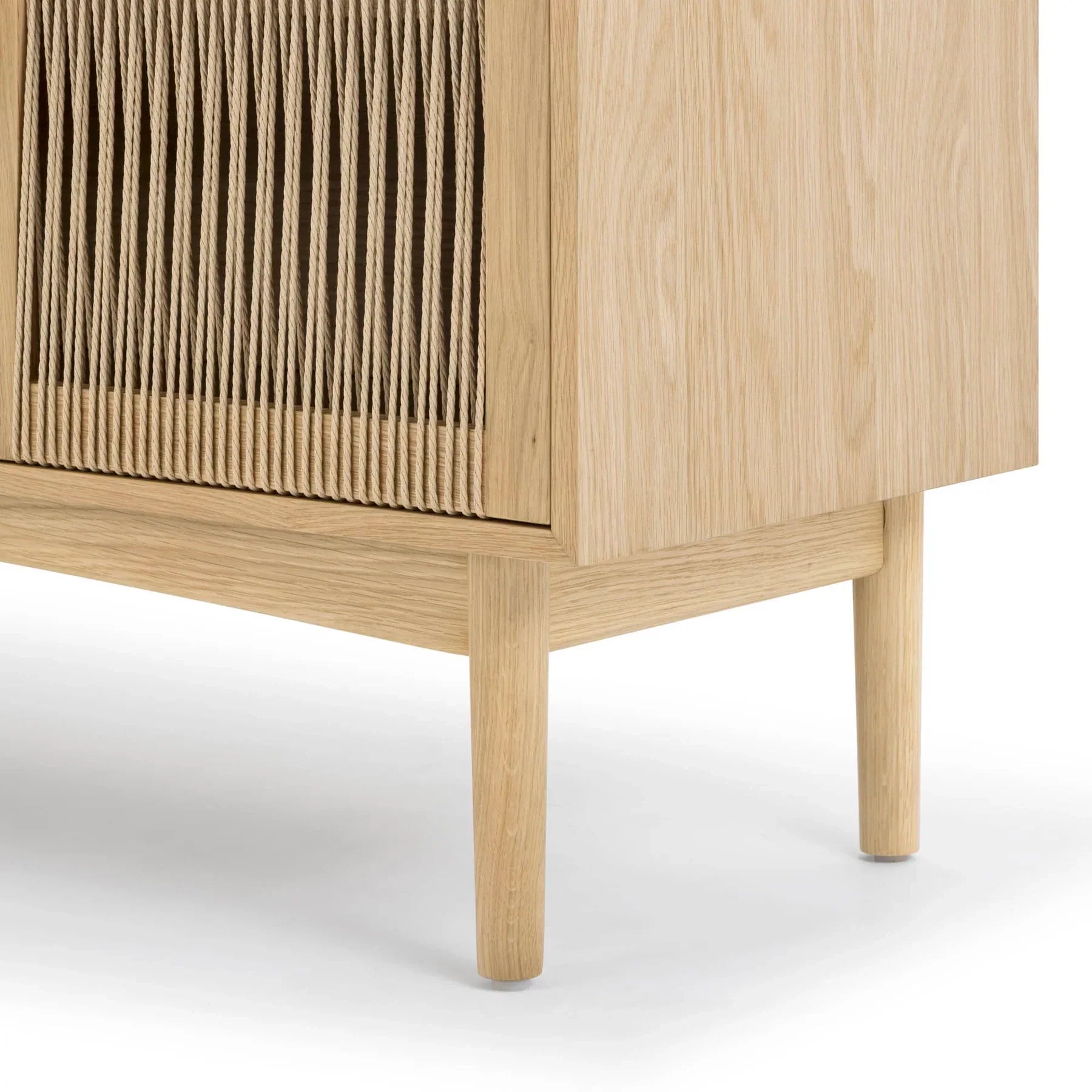 Front perspective view of the Lumina 4-door sideboard featuring a light oak wood frame, fluted glass door panels, and elegant vertical gold metal handles