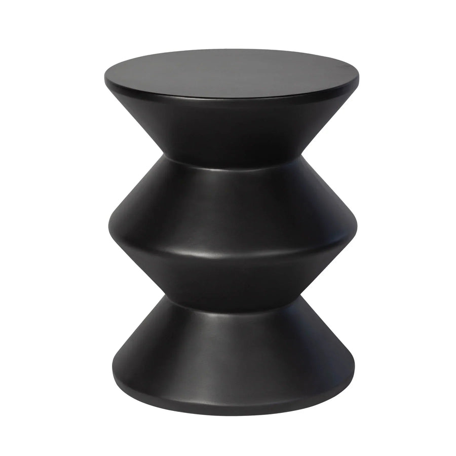 Three-quarter view of the concrete inverted side table featuring a matte black finish and a bold three-tier geometric zig-zag silhouette