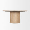 Three-quarter perspective view highlighting the seamless circular tabletop and the detailed vertical wood fluting on the base