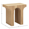 Lifestyle shot of the oak side table styled in a bright modern living room next to a beige sofa and minimalist decor