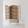 Studio lifestyle shot highlighting the elegant proportions and natural textures of the cane and oak wardrobe