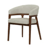 Three-quarter perspective view showcasing the curved backrest and clean minimalist silhouette of the upholstered chair