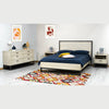 Angle lifestyle view of the styled bed highlighting the contrast between the dark metal frame and light wood panels