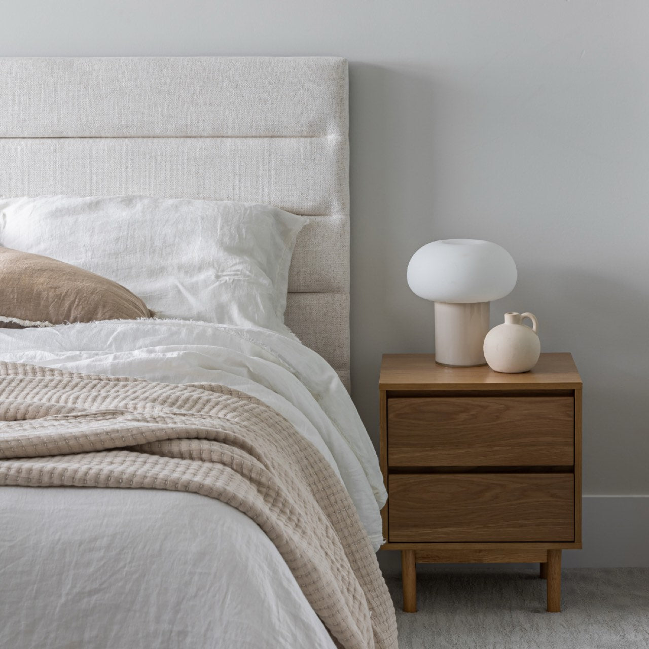 Front view of the Julia storage bed featuring a soft sand fabric and a modern horizontal channel tufted headboard