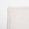 Lifestyle shot featuring the bed styled with olive green nightstands and a fluted white table lamp