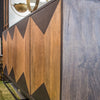 Perspective shot focusing on the high-quality geometric diamond wood inlay and the slim black metal sled base