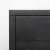 Close-up perspective of the front panel highlighting the precision joinery and the uniform matte black finish