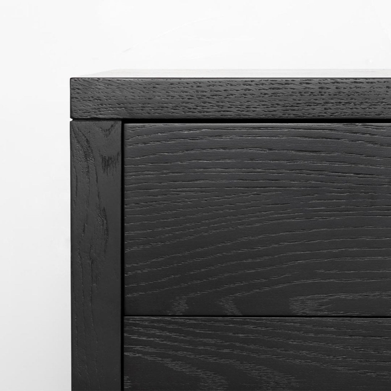 Close-up perspective of the front panel highlighting the precision joinery and the uniform matte black finish