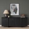 Lifestyle shot of the black oak sideboard styled with a large abstract painting and a neutral table lamp in a modern setting