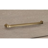 Macro detail shot focusing on the tactile oak wood grain and the modern slim brass drawer hardware