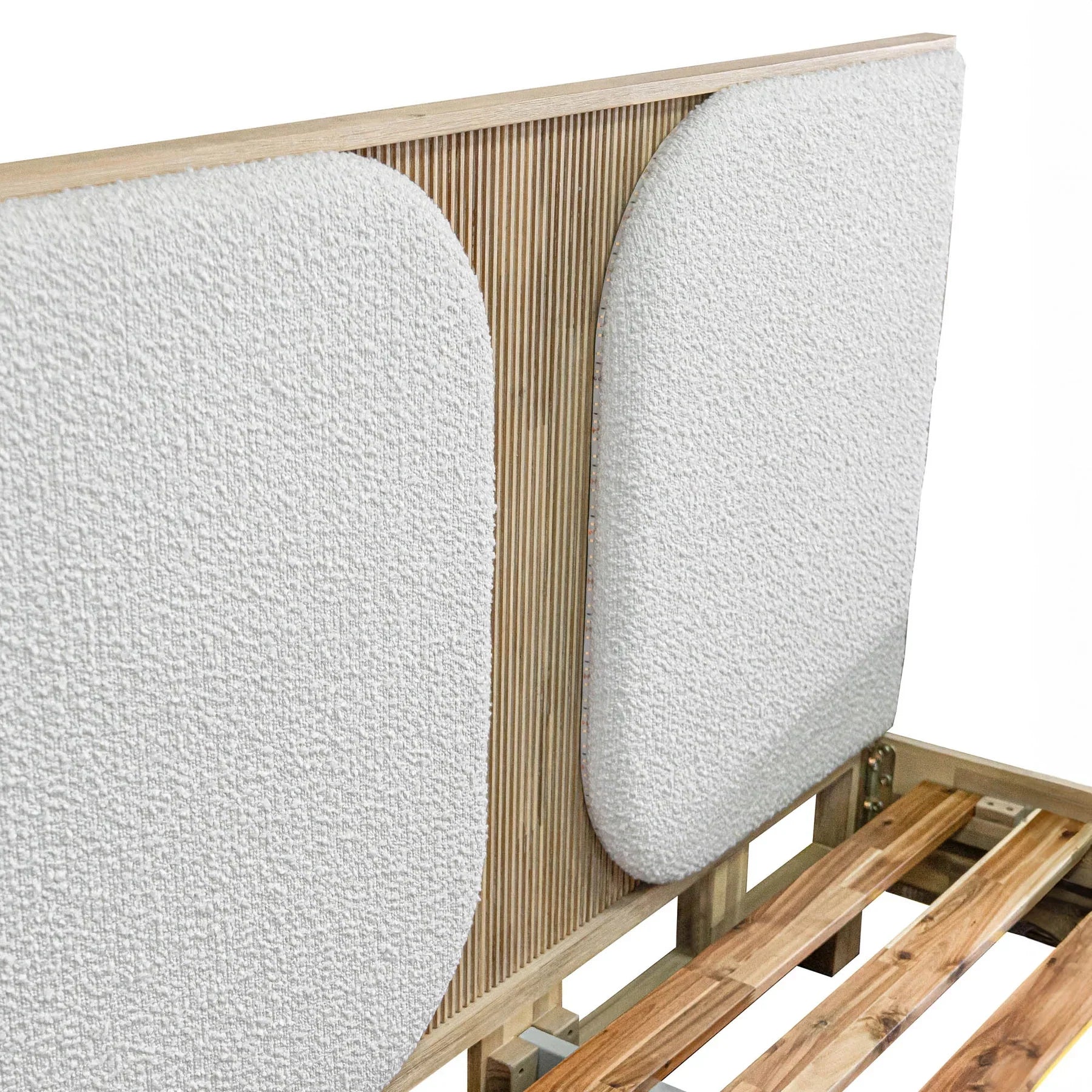 Front view of the Haru platform bed featuring a light driftwood frame and twin white bouclé upholstered headboard inserts