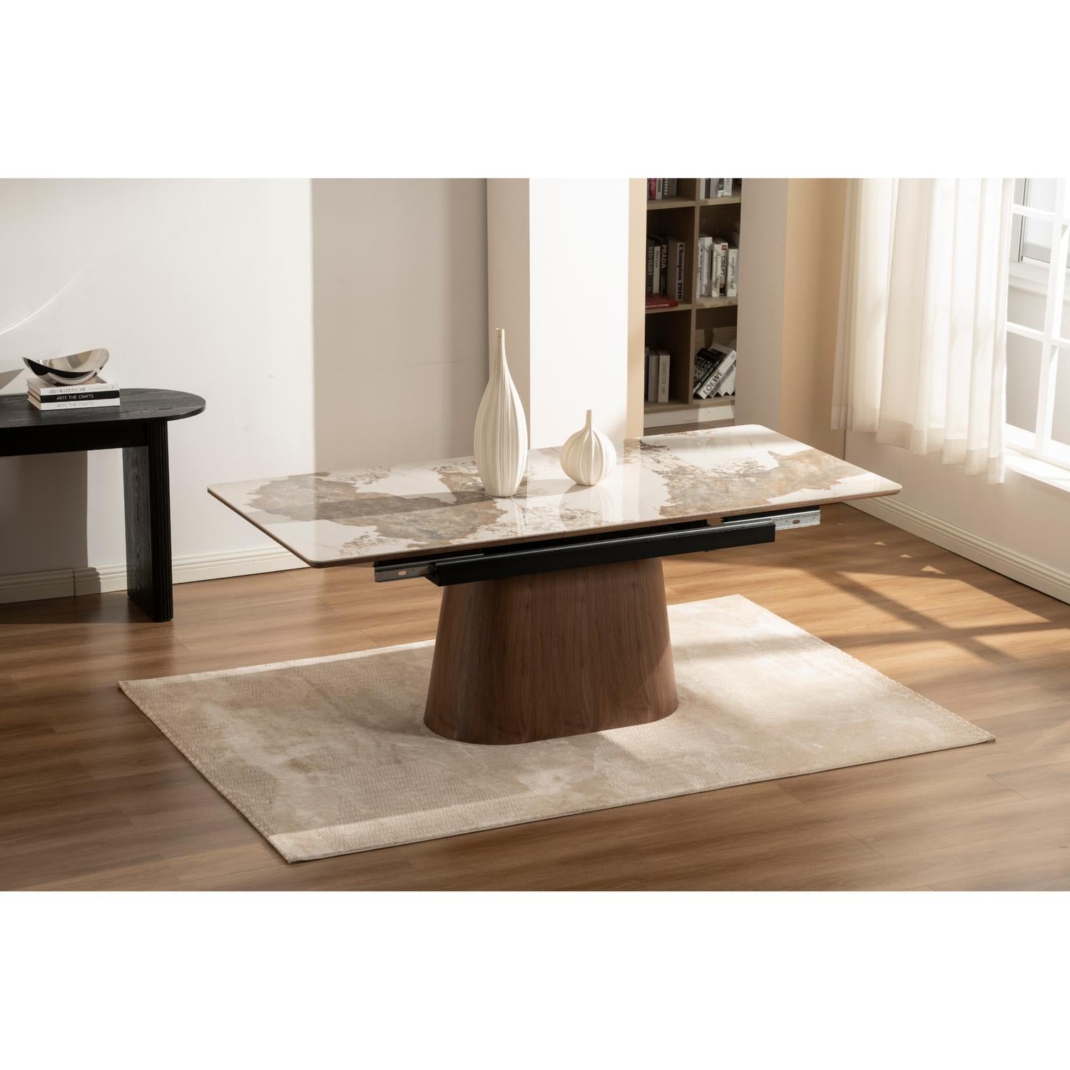 Front view of the Hyld extendable dining table featuring a white patterned ceramic top and a substantial walnut-finished wood pedestal base