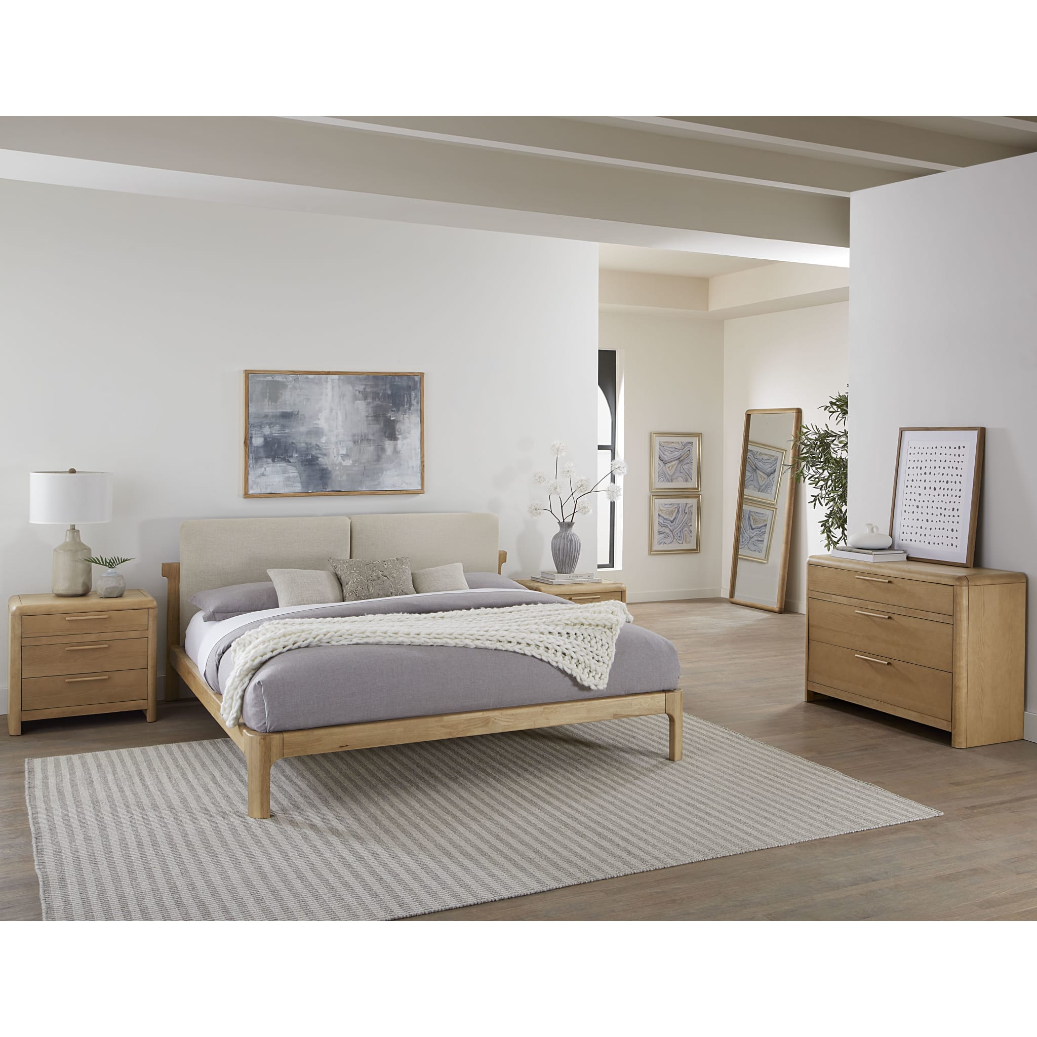 Front view of the Havn three-drawer nightstand in a warm ginger ash wood finish featuring soft rounded corners and minimalist wood handles