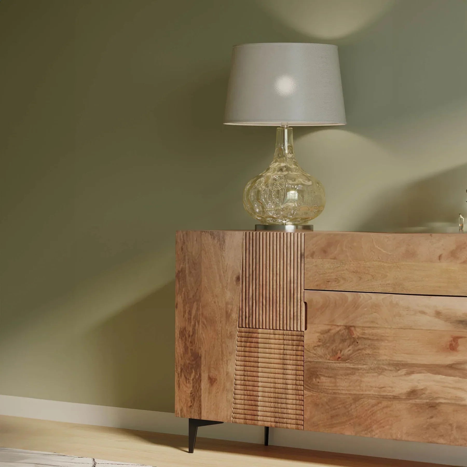 Front view of the Peyton sideboard featuring natural mango wood construction with unique geometric carved door panels and black metal legs