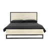 Straight-on lifestyle view of the bed in a bright studio setting with matching light oak nightstands
