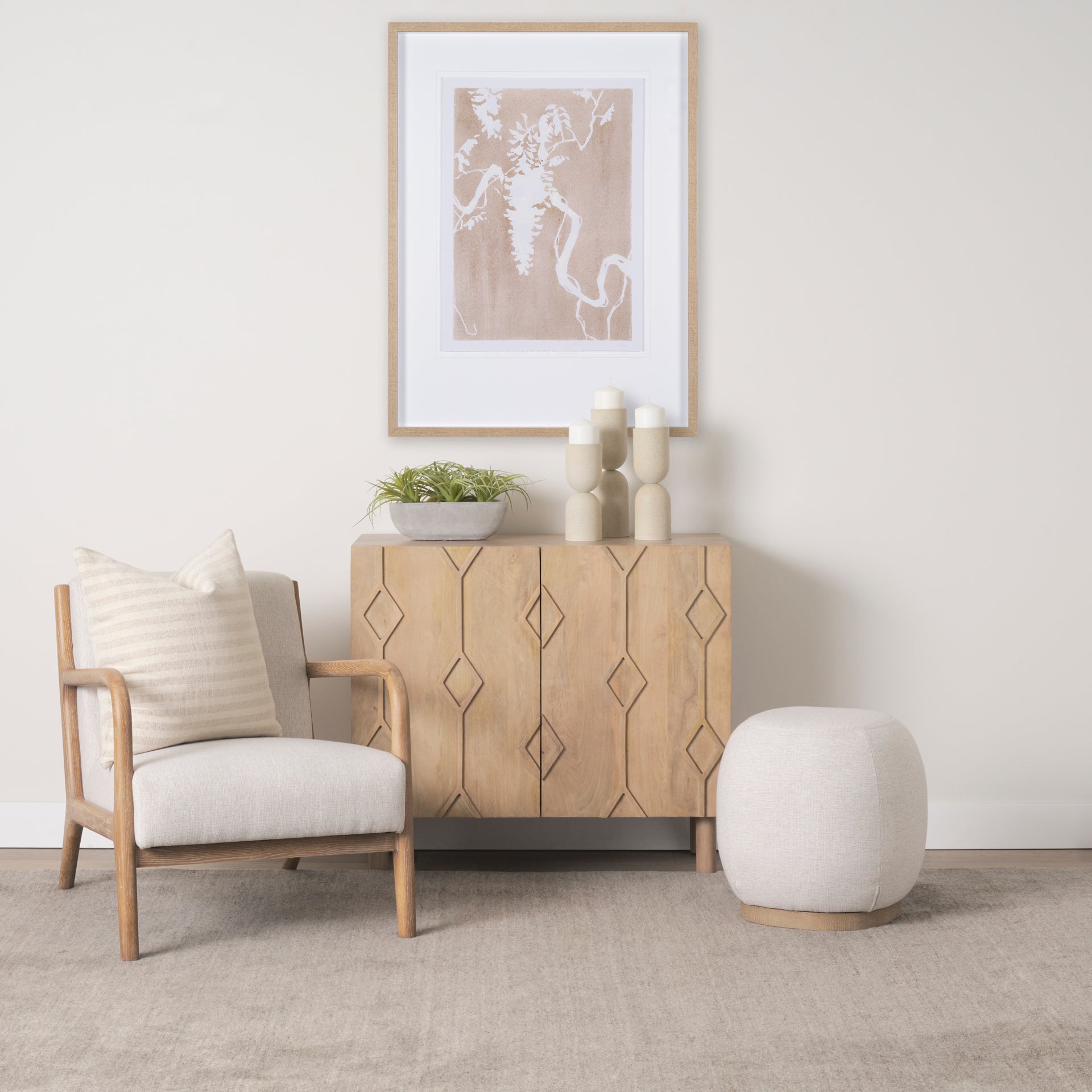 Front view of the Heera accent cabinet featuring a light brown wood finish and a decorative carved diamond motif on the double doors