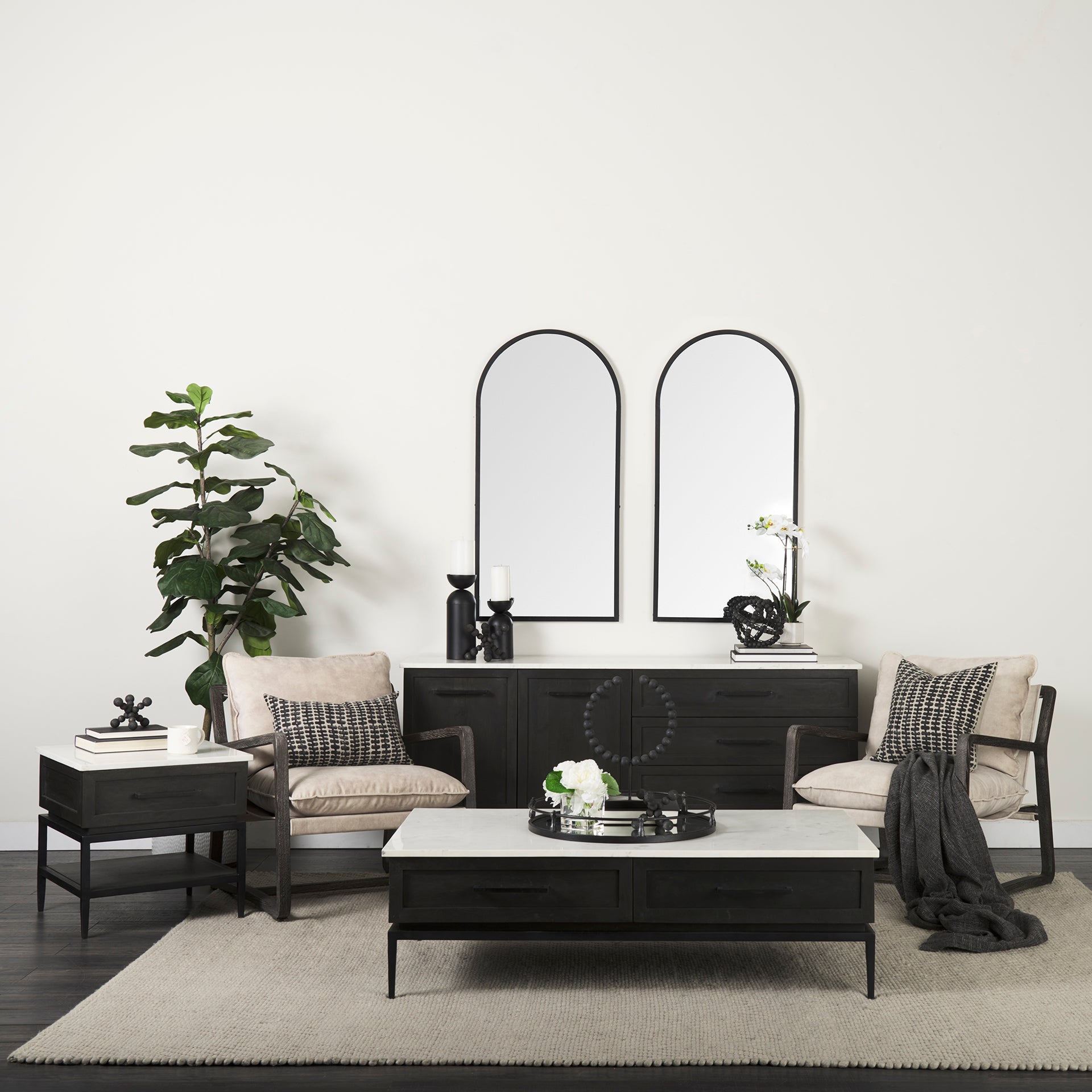 Front perspective view of the Gemma sideboard featuring a dark charcoal wood finish, a white marble top, and slim black metal legs