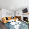 Lifestyle shot featuring the Remix sideboard styled behind a tan leather sofa in a bright modern living room