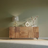 Lifestyle shot featuring the Peyton sideboard styled in a warm room with a modern lamp and neutral decor