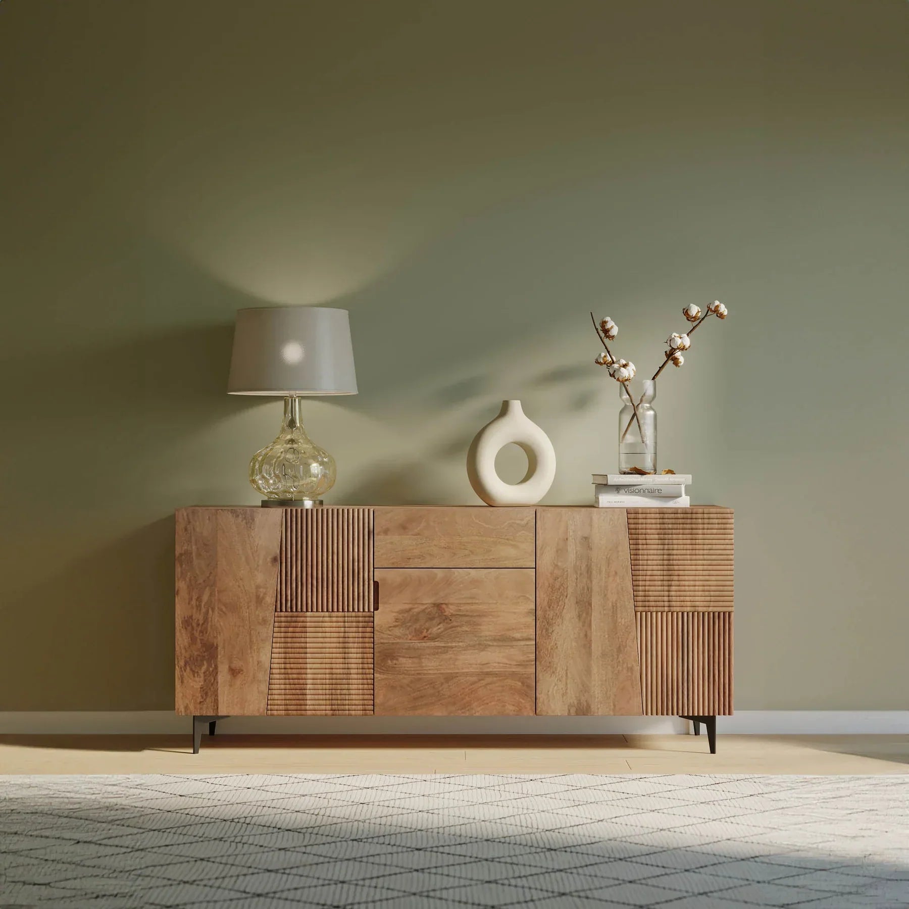 Front view of the Peyton sideboard featuring natural mango wood construction with unique geometric carved door panels and black metal legs