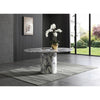 Studio lifestyle shot featuring the Sille pedestal table styled with an orchid centerpiece on a grey textured rug