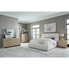 Wide lifestyle shot showcasing the Bjorn bed styled with matching chai wood nightstands and dresser in a bright modern suite