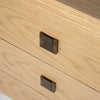 Close-up perspective of the front facade highlighting the uniform spacing of the bronze knobs and the seamless drawer alignment