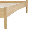 Close-up of the bed frame corner showcasing the seamless joinery and architectural side rail profile