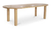 Three-quarter perspective view showcasing the soft curved edges and minimalist architectural design of the oak dining table