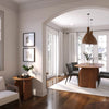 Lifestyle perspective of the table styled in an arched dining nook with modern art and warm ambient lighting