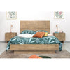 Detail lifestyle shot showcasing the headboard texture alongside a coordinating wood dresser and warm accent lighting