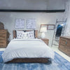 Alternate lifestyle perspective showcasing the Nevada chest as part of a cohesive rustic bedroom collection with minimalist decor