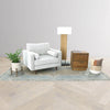 Versatile lifestyle shot featuring the nightstand used as an end table next to a white accent chair and modern floor lamp