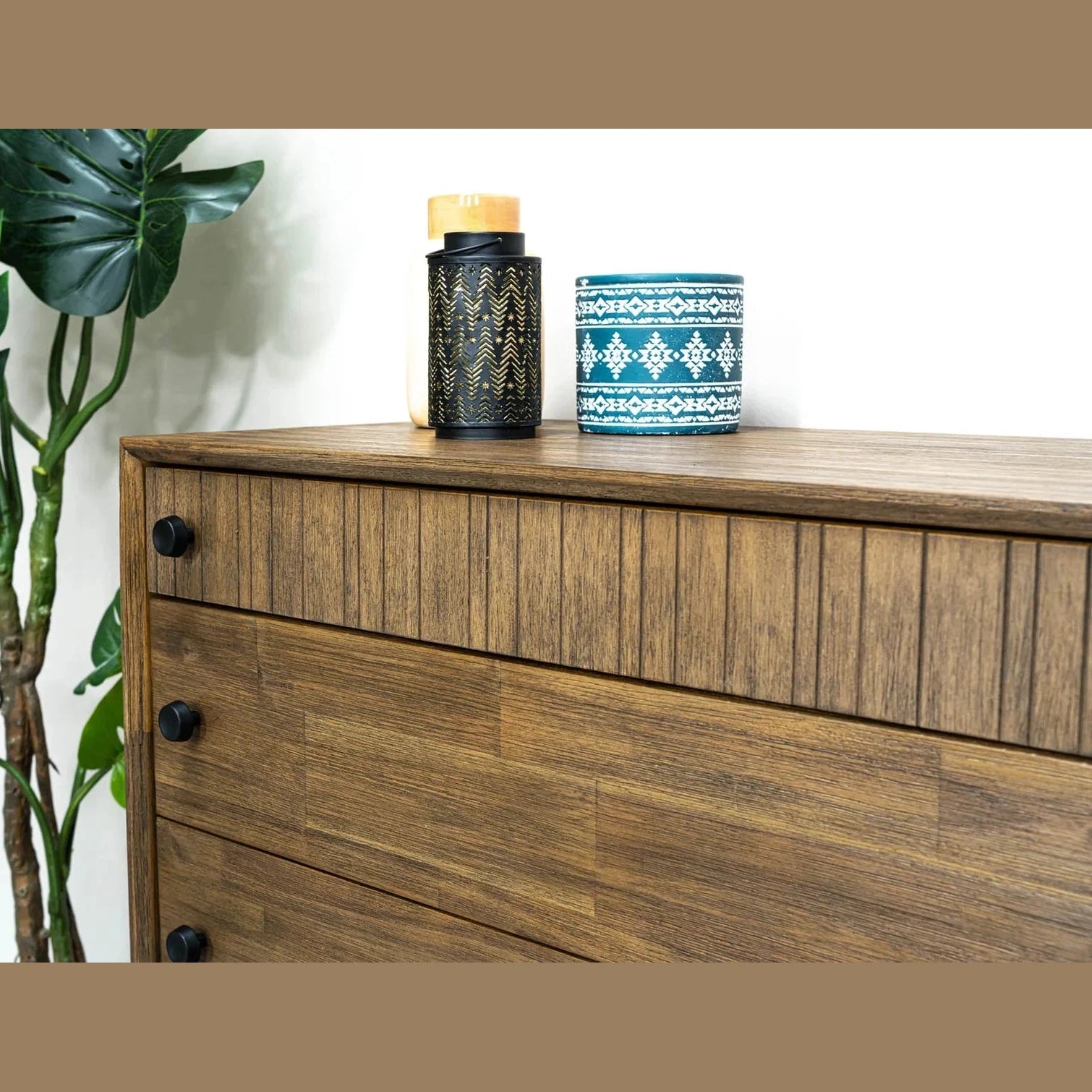 Front view of the West 5-drawer vertical chest featuring a rich natural wood finish, dark circular knobs, and a top drawer with vertical fluted detailing
