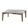 Lifestyle shot showing the Cosimo coffee table styled in a contemporary living room with a patterned rug and grey sofa