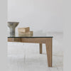 Profile view highlighting the clean architectural lines and slightly tapered wooden legs of the Cosimo table