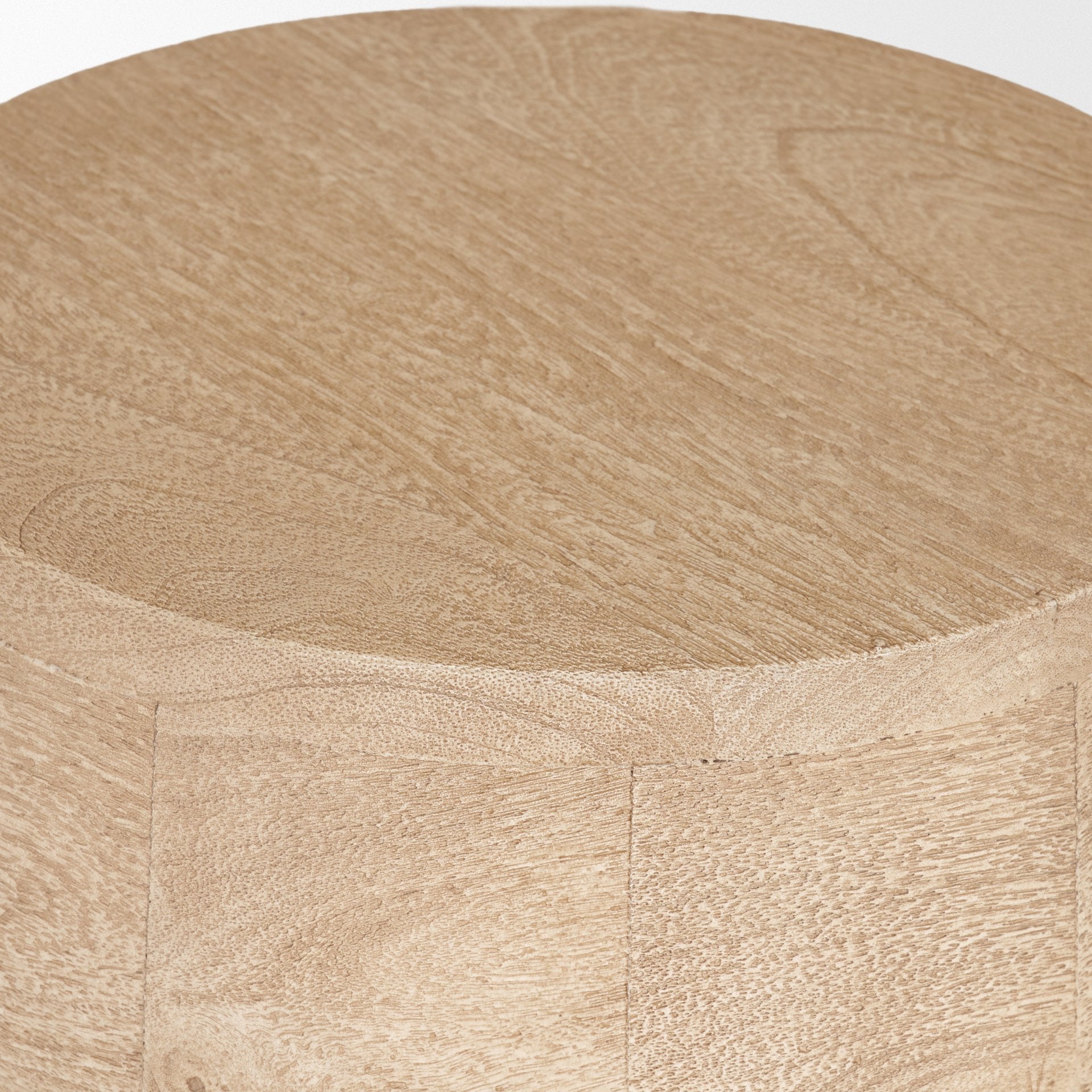 Macro view of the circular tabletop surface showcasing the natural light wood grain and smooth matte finish
