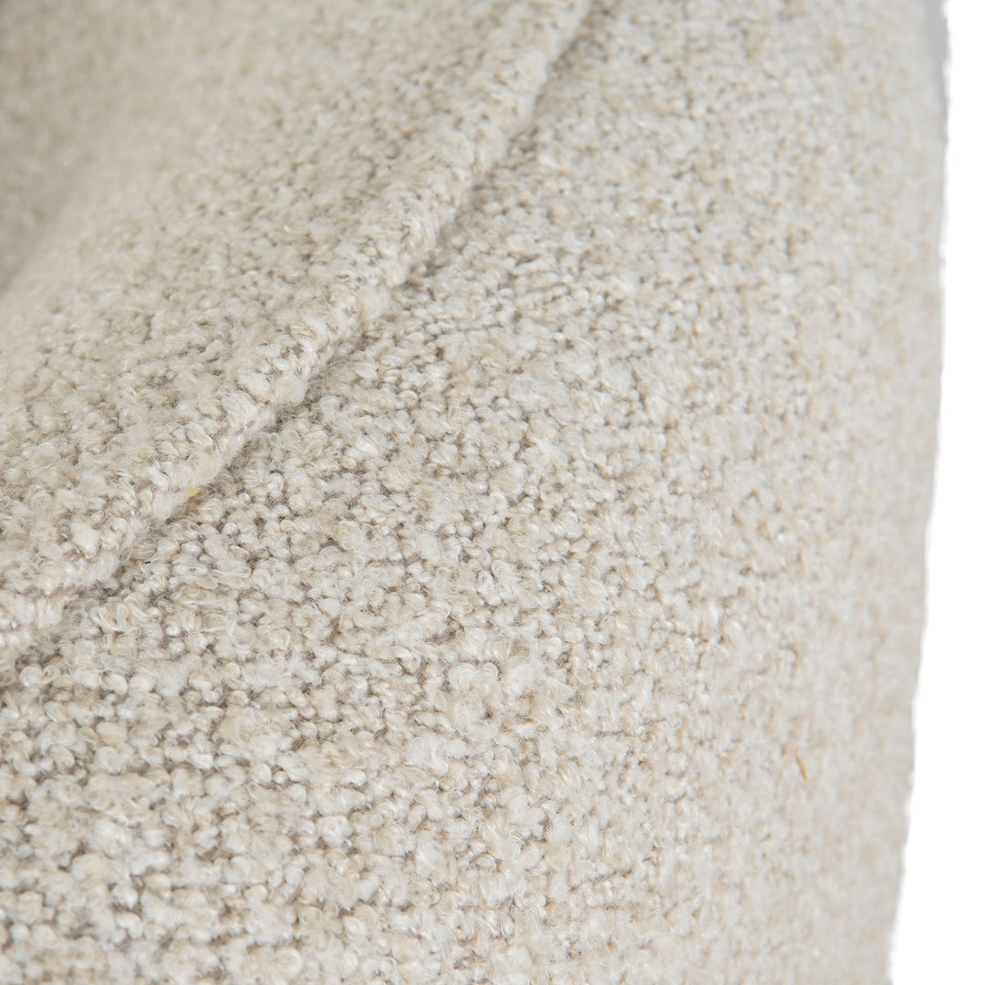 Full-frame macro shot of the cream bouclé fabric for material and tactile reference