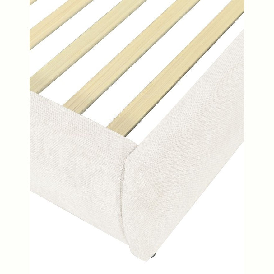 Front view of the Aici storage bed featuring a cream fabric finish and a unique V-shaped geometric stitched headboard
