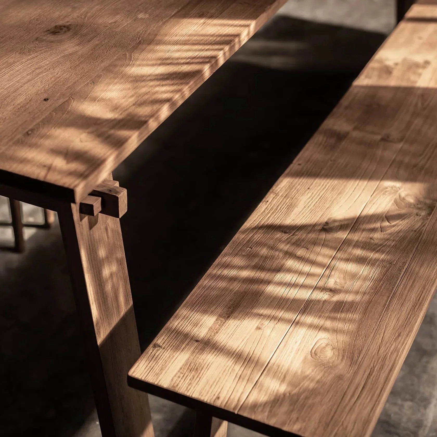 Front view of the D-Bodhi Artisan bench showcasing its long minimalist profile and natural reclaimed wood texture
