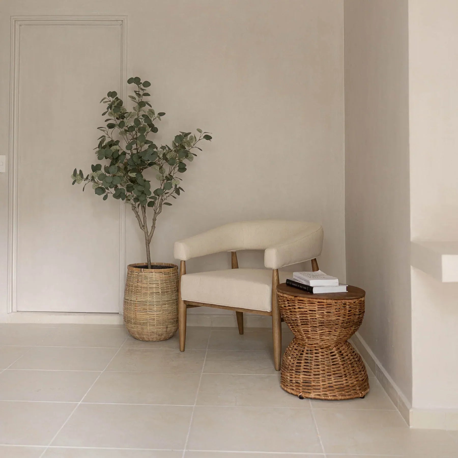 Front view of the D-Bodhi Rebana Alto side table featuring a hand-woven natural rattan hourglass base and a smooth circular reclaimed wood top